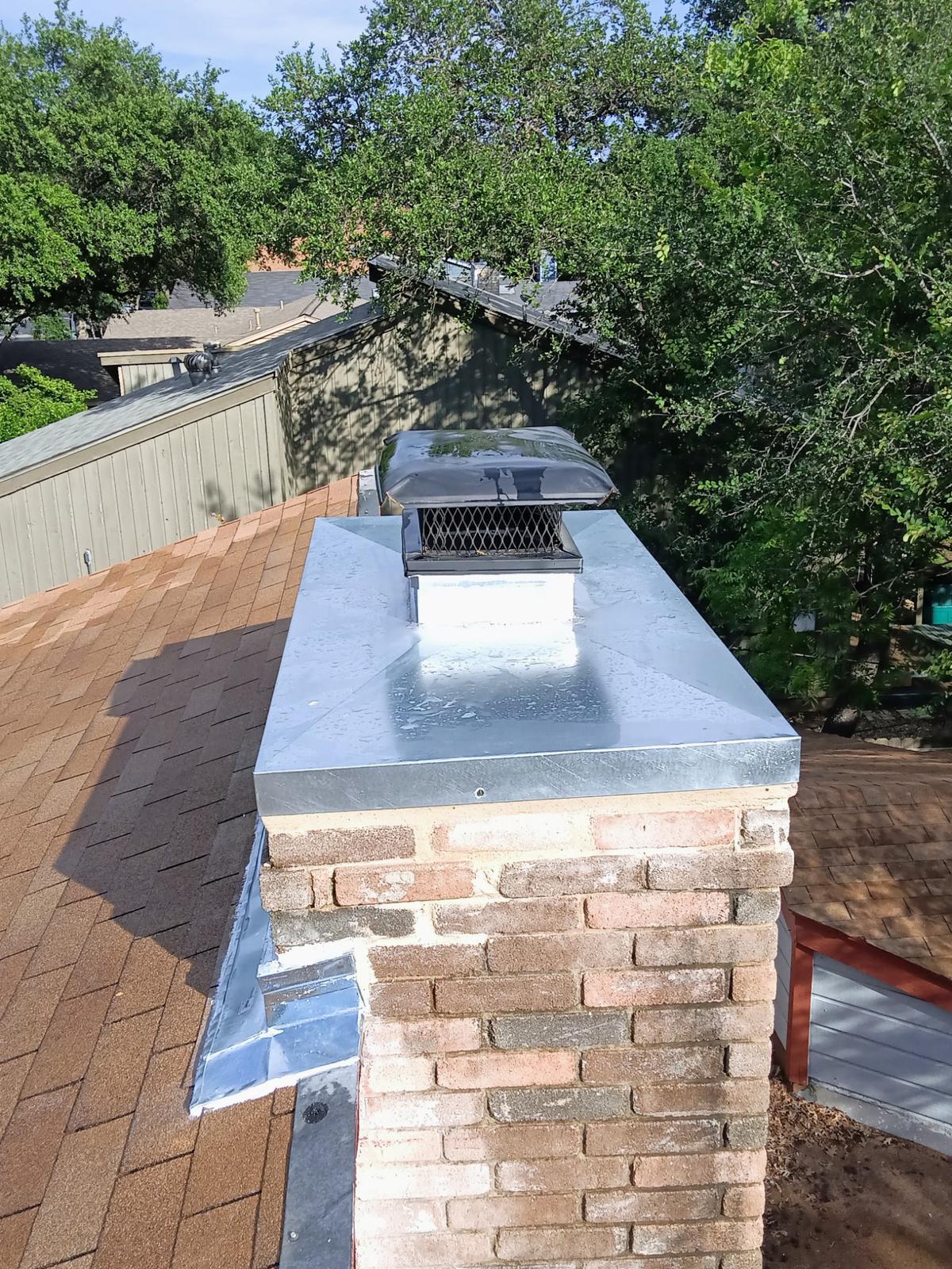 Brick chimney fitted with a new metal chase cover and cap