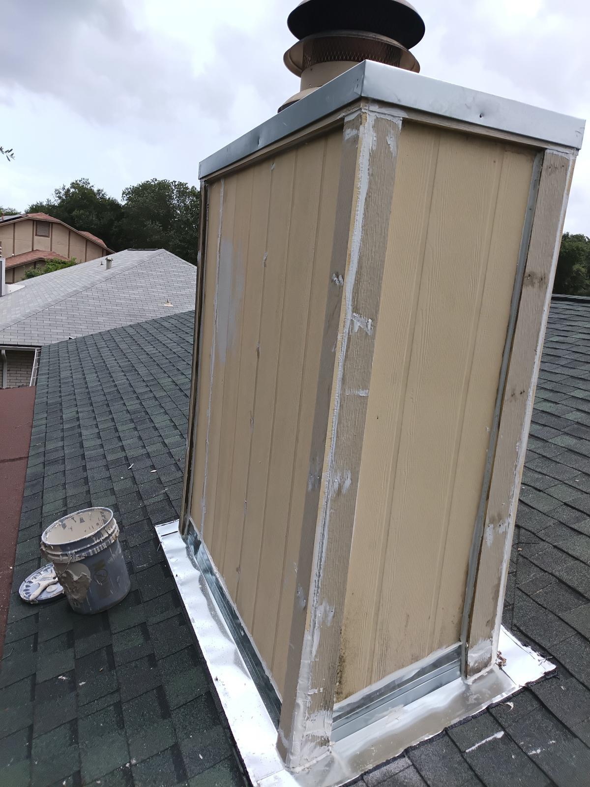 Chimney chase siding sealed with new metal flashing