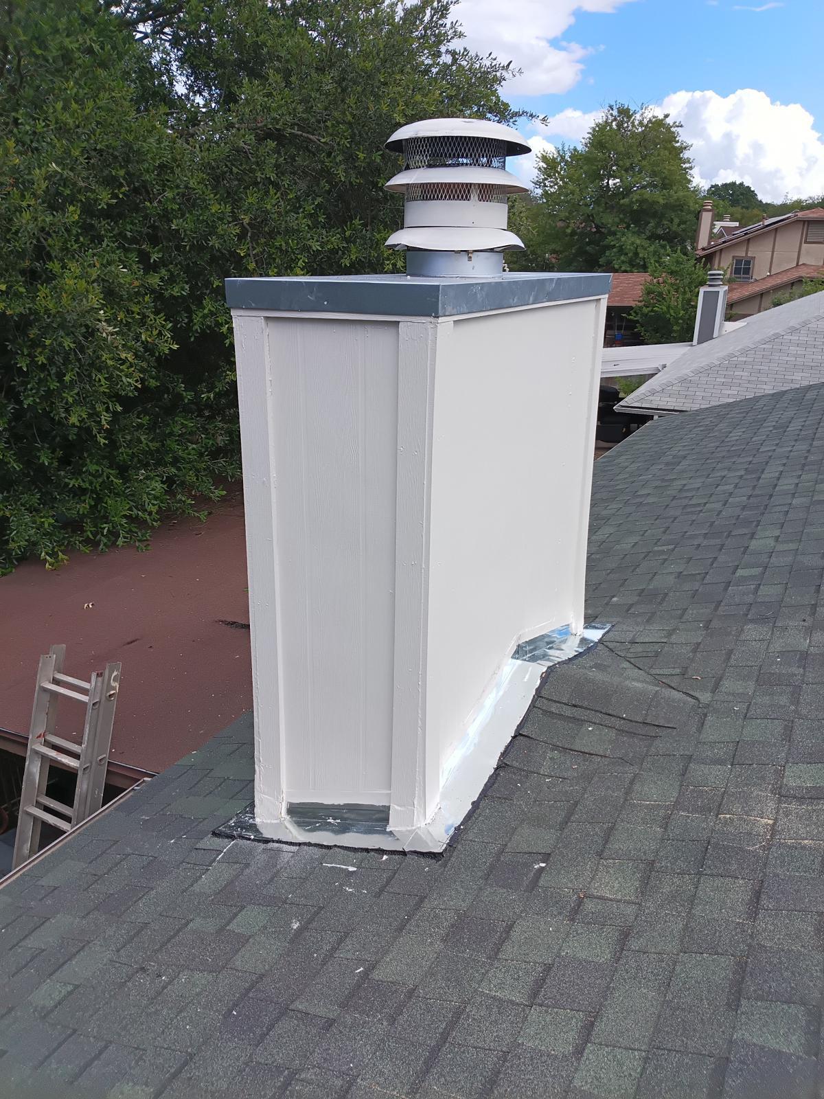 Repaired chimney chase with new flashing on a shingle roof