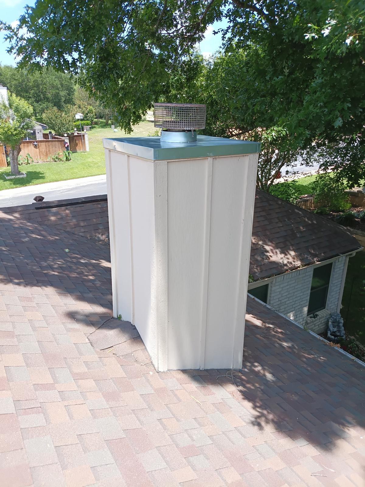 Brick chimney with new metal crown cover and cap installed